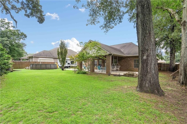 view of yard featuring a fenced in pool and a patio area