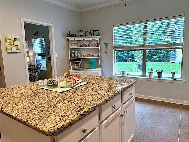 kitchen with tile patterned flooring, a center island, and white cabinets