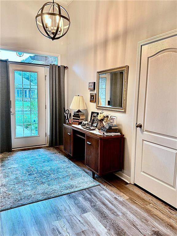 entrance foyer featuring hardwood / wood-style flooring and a notable chandelier