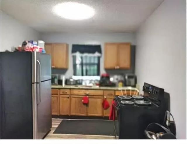 361 Fredonia St, Mobile, AL 36607 - kitchen featuring freestanding refrigerator, black electric range oven, and light countertops