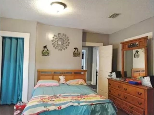 361 Fredonia St, Mobile, AL 36607 - bedroom with visible vents and a textured ceiling
