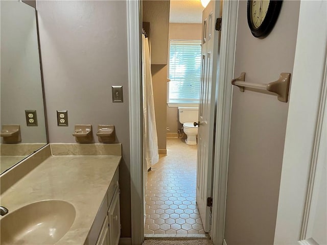 bathroom with tile patterned floors, vanity, and toilet