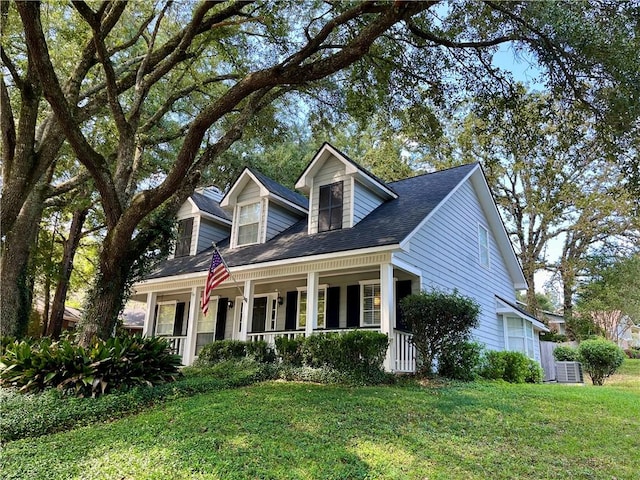 new england style home featuring a front lawn and covered porch