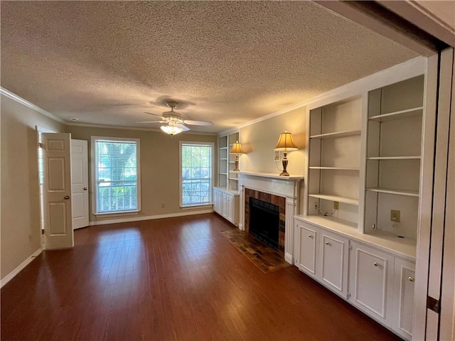 unfurnished living room featuring a textured ceiling, ornamental molding, and dark hardwood / wood-style floors