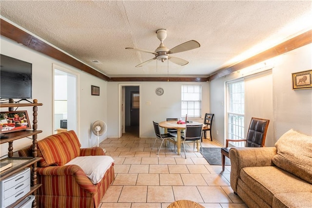 living room featuring ceiling fan, a textured ceiling, and light tile patterned floors