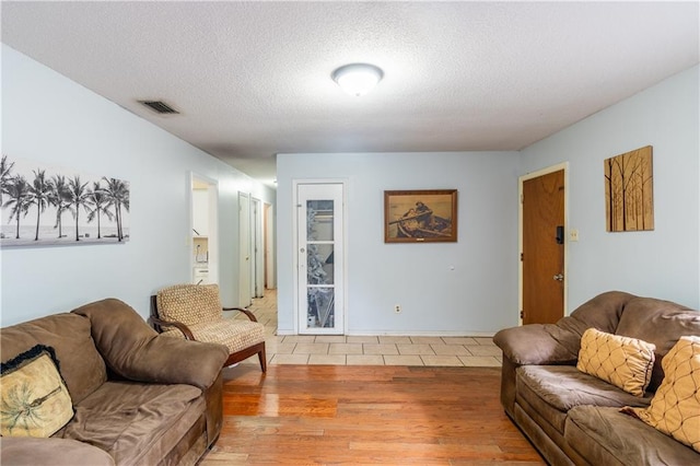 living room with hardwood / wood-style flooring and a textured ceiling