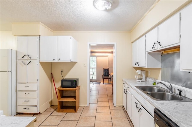 kitchen featuring white refrigerator, white cabinets, dishwasher, a textured ceiling, and sink