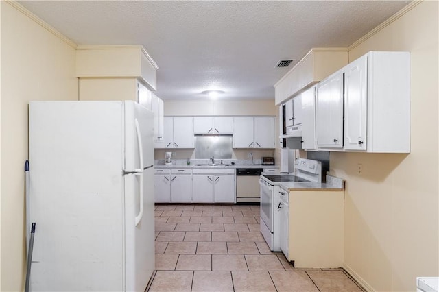 kitchen featuring ornamental molding, white appliances, a textured ceiling, and white cabinetry