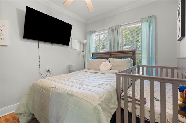 bedroom with a ceiling fan, baseboards, and ornamental molding