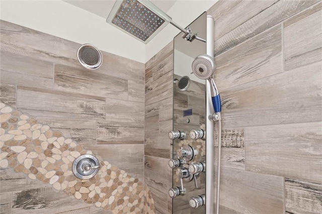 interior details featuring a tile shower