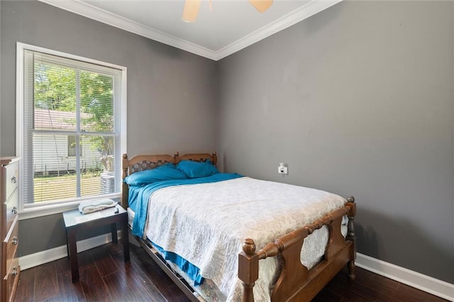 bedroom featuring wood finished floors, crown molding, baseboards, and a ceiling fan