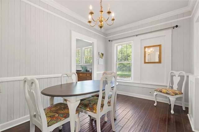 dining room featuring baseboards, crown molding, dark wood-style floors, and a notable chandelier