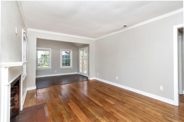 unfurnished living room with a fireplace with flush hearth, visible vents, baseboards, ornamental molding, and wood-type flooring