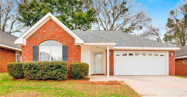 ranch-style house with a garage and a front lawn