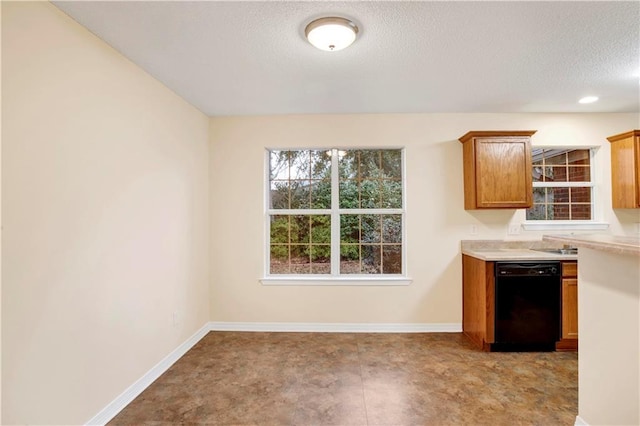 kitchen featuring black dishwasher and a textured ceiling