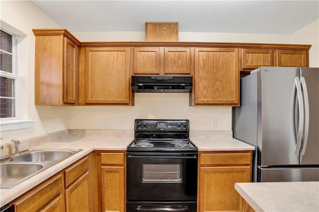 kitchen with sink, stainless steel refrigerator, extractor fan, black electric range, and a textured ceiling