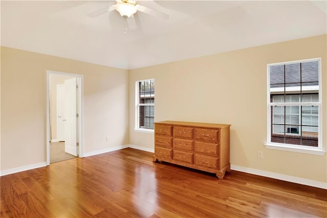 unfurnished bedroom featuring wood-type flooring and ceiling fan