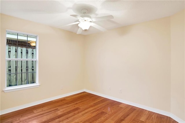 unfurnished room with hardwood / wood-style flooring and ceiling fan