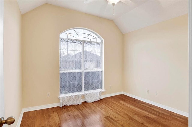 unfurnished room with lofted ceiling, wood-type flooring, and ceiling fan