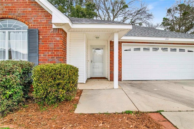 doorway to property with a garage