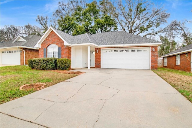 single story home featuring a garage and a front lawn