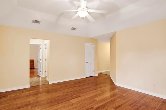 spare room with ceiling fan, wood-type flooring, and lofted ceiling