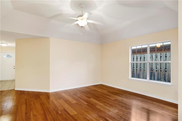 unfurnished room featuring ceiling fan, wood-type flooring, and lofted ceiling