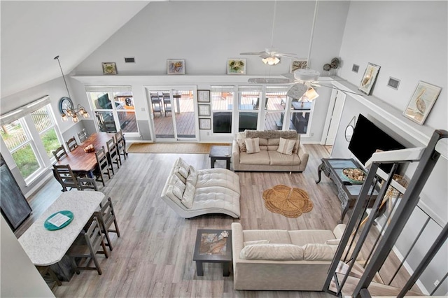 living area with high vaulted ceiling, ceiling fan, and wood finished floors