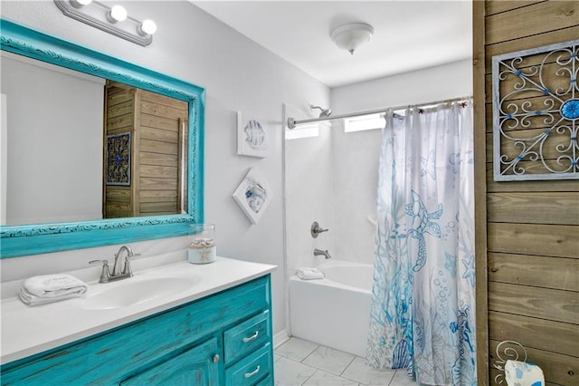 full bath with marble finish floor, vanity, and shower / tub combo with curtain