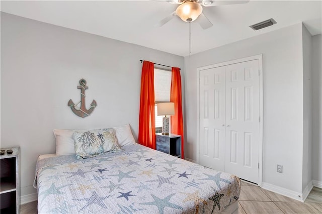 bedroom featuring visible vents, baseboards, a closet, and ceiling fan