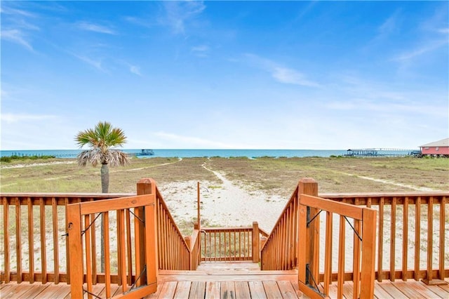 deck featuring a water view and a view of the beach