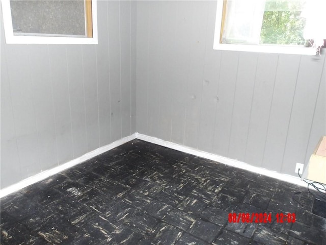 spare room with baseboards