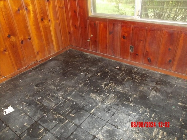 spare room featuring wood walls and tile patterned floors