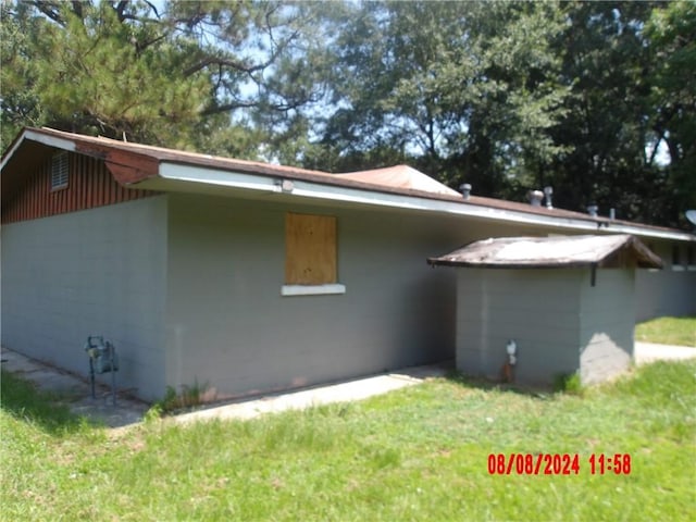 view of side of home with concrete block siding