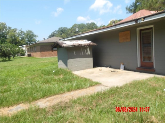 rear view of property featuring a patio and a yard