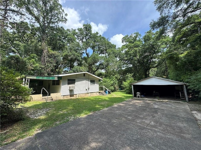 334 Avondale Ave, Satsuma, AL 36572 - view of home's exterior with driveway, a yard, and a detached carport