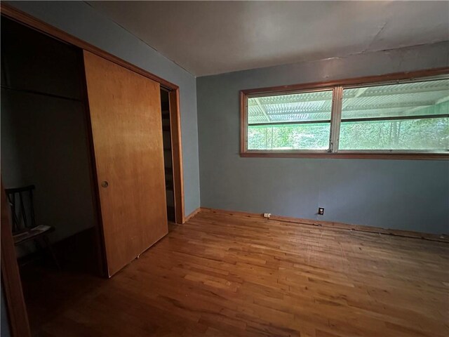 334 Avondale Ave, Satsuma, AL 36572 - unfurnished bedroom featuring wood finished floors and a closet