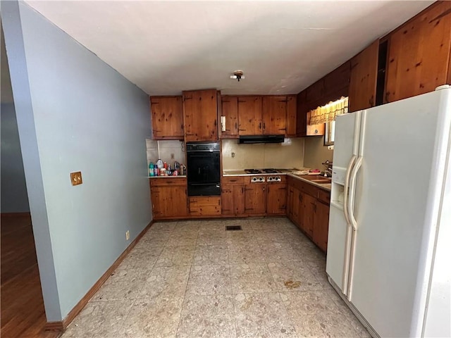 334 Avondale Ave, Satsuma, AL 36572 - kitchen with white refrigerator with ice dispenser, oven, brown cabinetry, a warming drawer, and under cabinet range hood