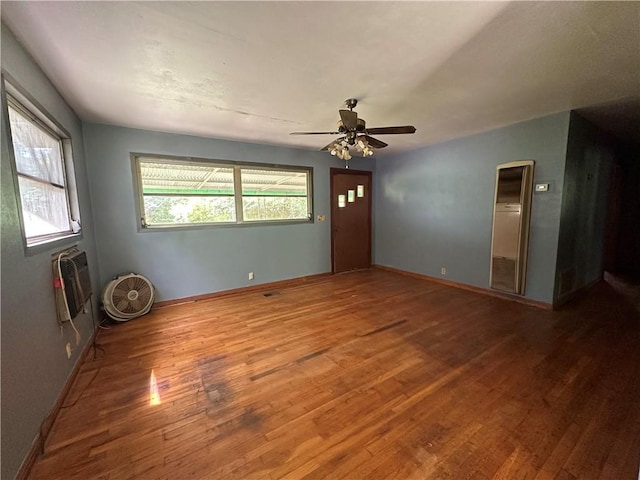 334 Avondale Ave, Satsuma, AL 36572 - empty room featuring wood finished floors, ceiling fan, baseboards, and a wall unit AC