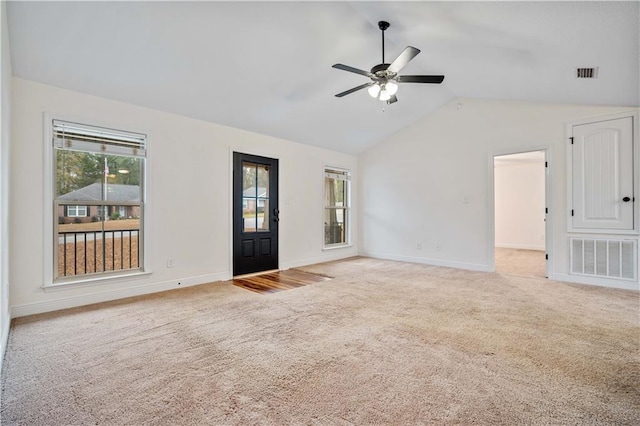 unfurnished living room with lofted ceiling, light colored carpet, and ceiling fan