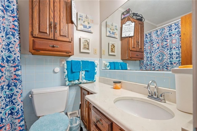 bathroom with vanity, tile walls, and toilet