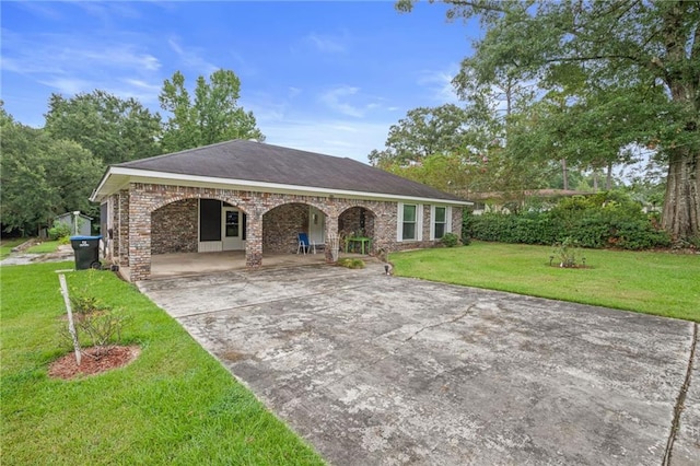 ranch-style home with a front yard and a carport