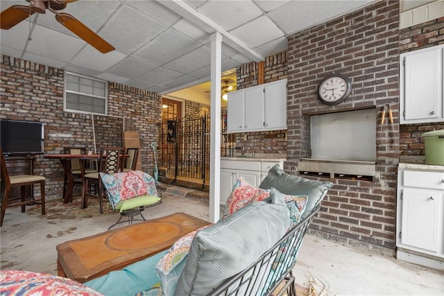 interior space with an outdoor bar, ceiling fan, and exterior kitchen