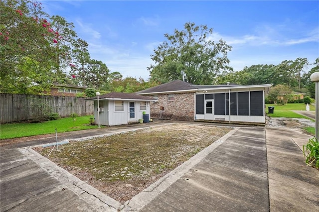 back of property with a yard and an outbuilding