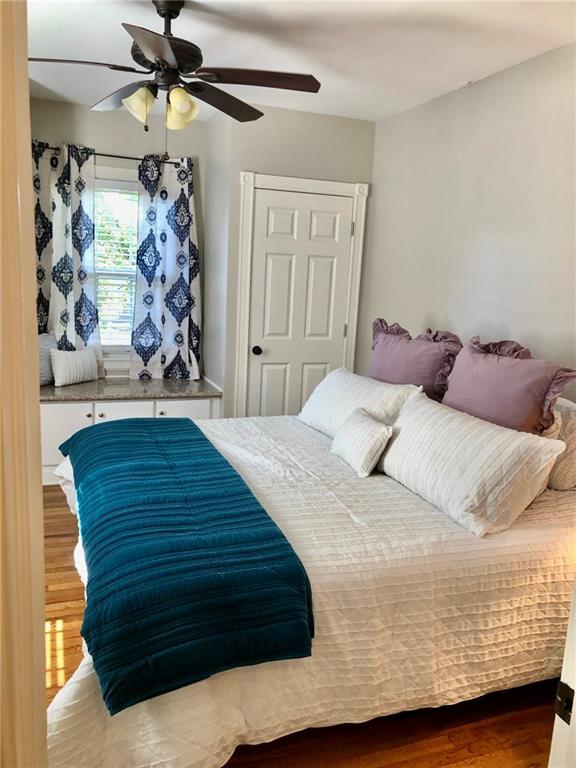 bedroom featuring ceiling fan and wood-type flooring