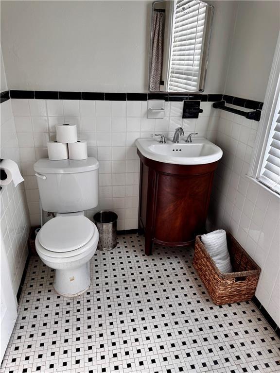 bathroom with plenty of natural light, tile walls, and vanity