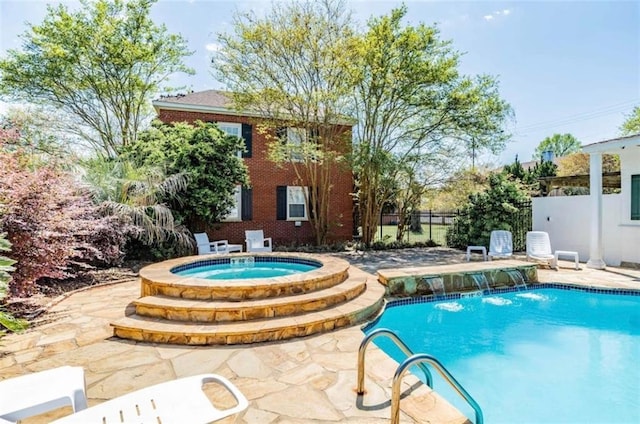 view of swimming pool featuring a patio area, an in ground hot tub, and pool water feature