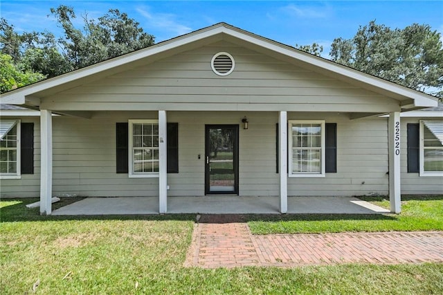 view of front facade with a front lawn and a porch