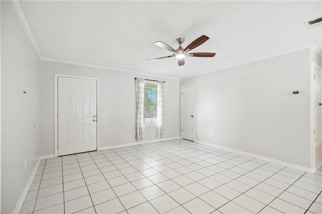 spare room with a textured ceiling, ceiling fan, light tile patterned flooring, and ornamental molding