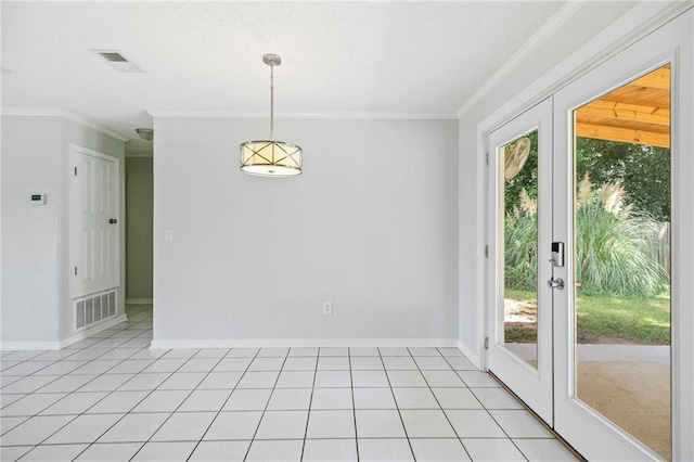 empty room featuring light tile patterned flooring, ornamental molding, and french doors